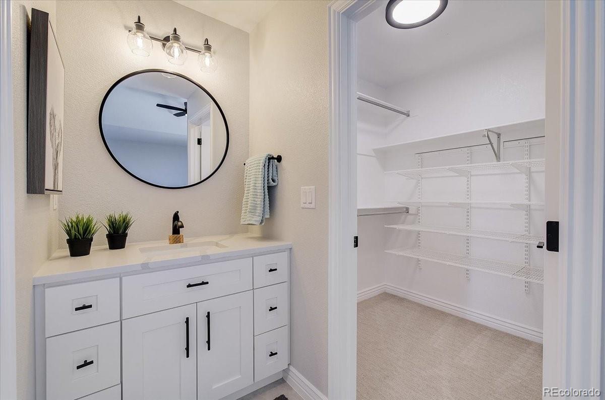 6063 South Eagle Street Centennial, CO 80016 - Photo 19 of 40 a bathroom with a sink and a mirror