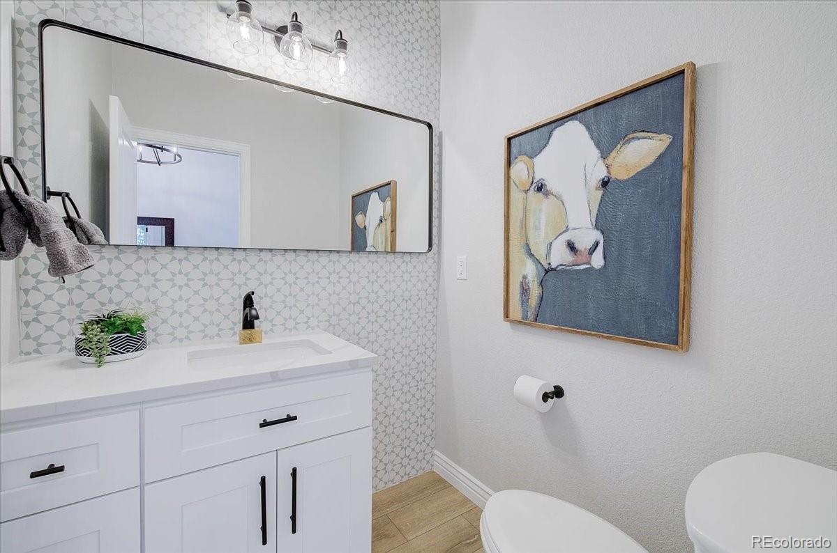 6063 South Eagle Street Centennial, CO 80016 - Photo 20 of 40 a bathroom with a toilet sink and mirror