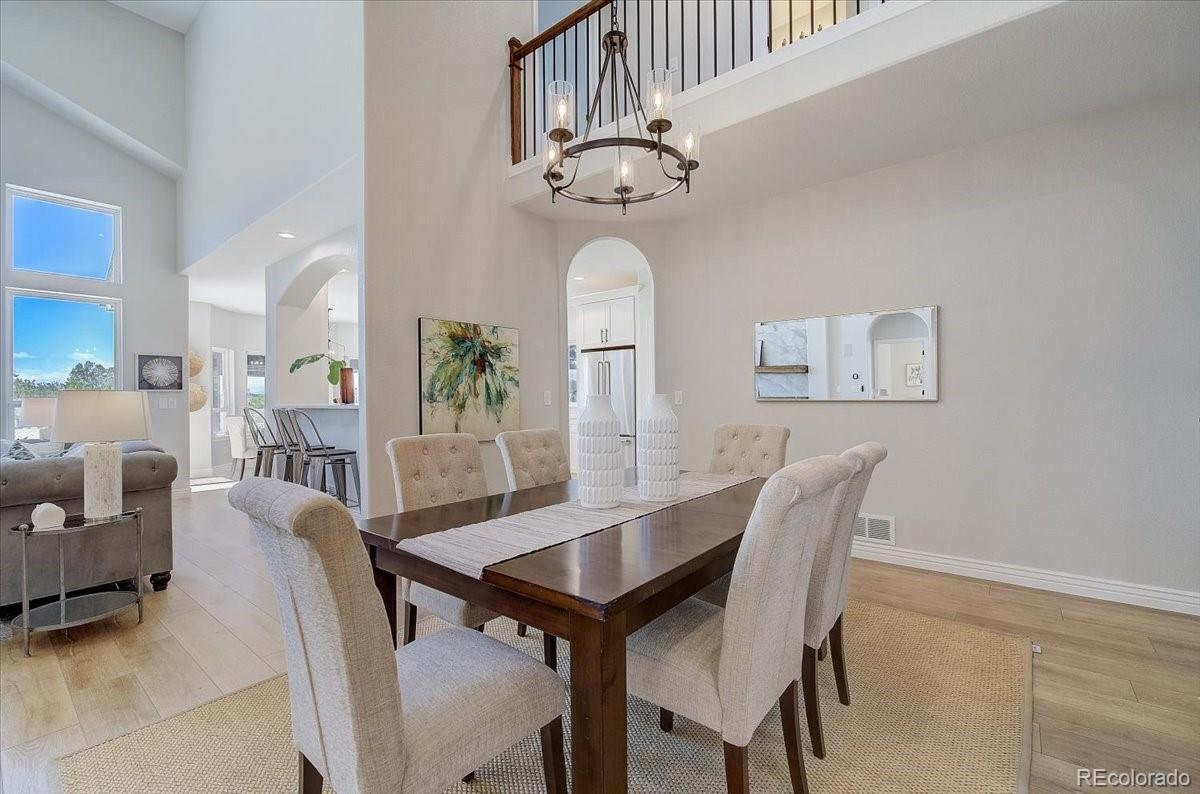 6063 South Eagle Street Centennial, CO 80016 - Photo 7 of 40 a view of a dining room with furniture and a chandelier