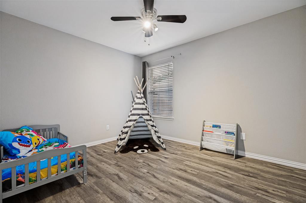 4305 Ridgewood Road Melissa, TX 75454 - Photo 17 of 26 Bedroom with wood-finish flooring and a ceiling fan with light fixture