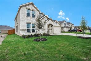 817 Paper Daisy Path Leander, TX 78641 - Photo 2 of 12 A well-maintained lawn welcomes you to this attractive residence with a two-car garage.