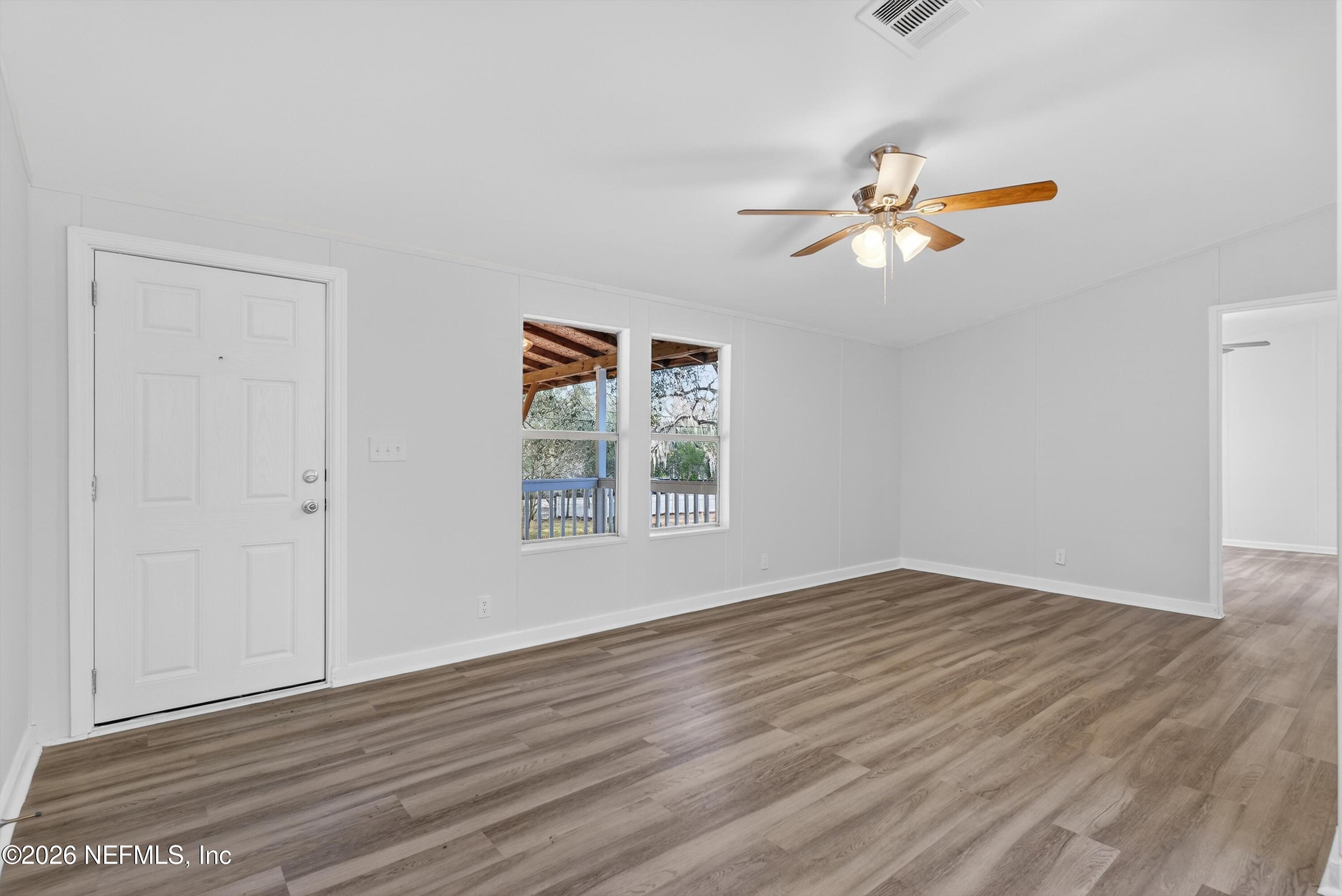 7595 Oak Forest Road Keystone Heights, FL 32656 - Photo 10 of 49 a view of empty room with wooden floor and fan