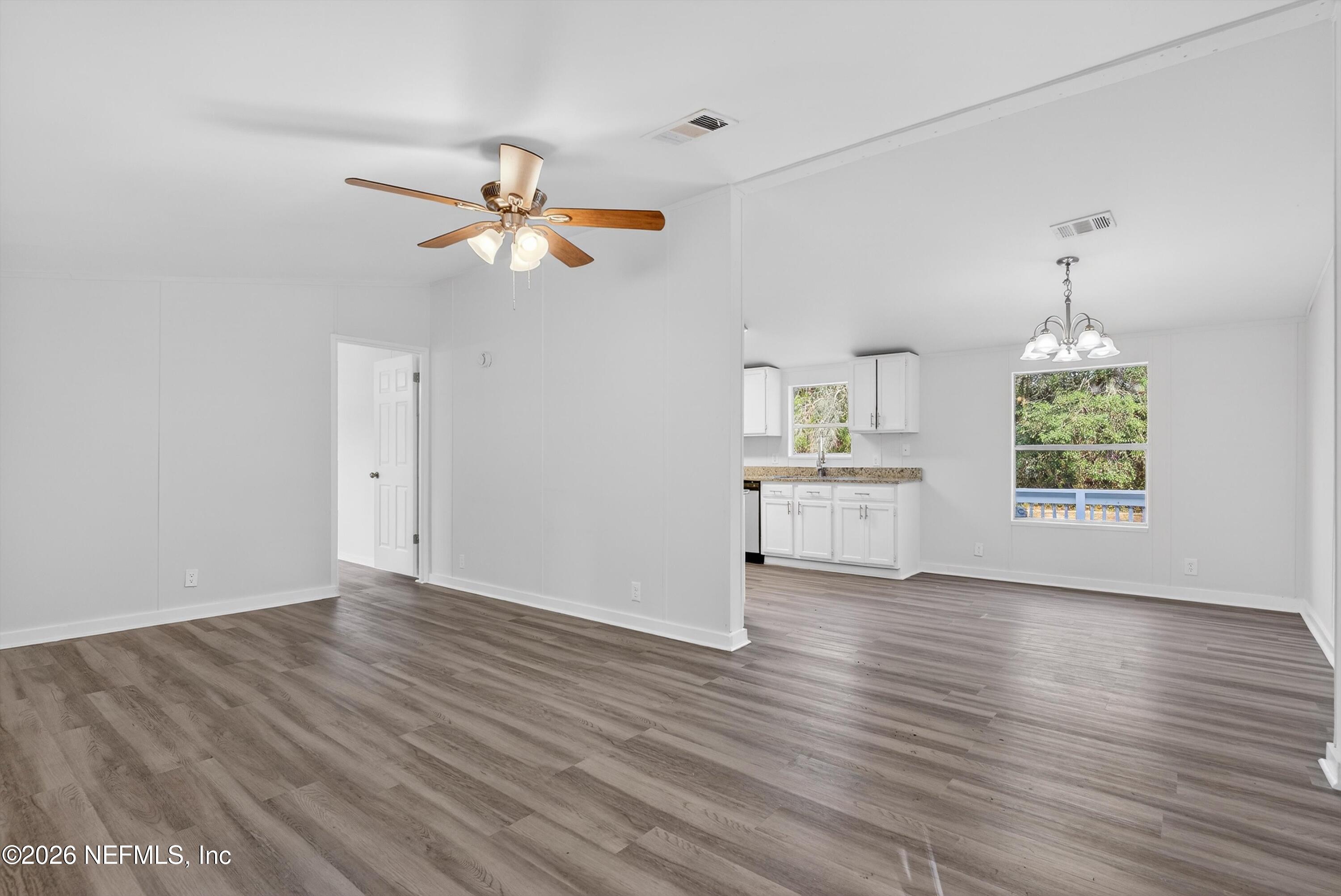 7595 Oak Forest Road Keystone Heights, FL 32656 - Photo 12 of 49 wooden floor in an empty room with a window