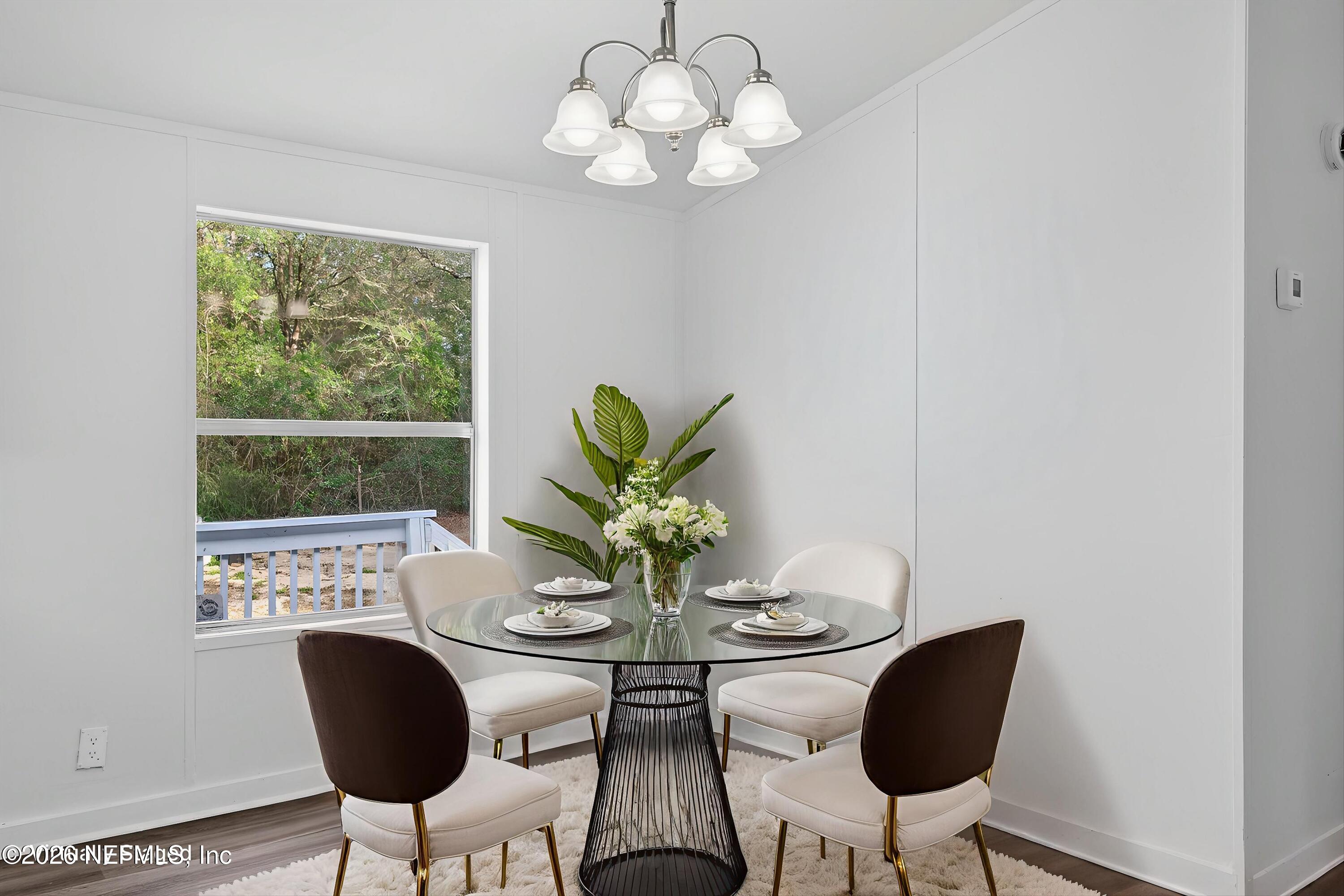 7595 Oak Forest Road Keystone Heights, FL 32656 - Photo 13 of 49 a view of a dining room with furniture wooden floor and a chandelier