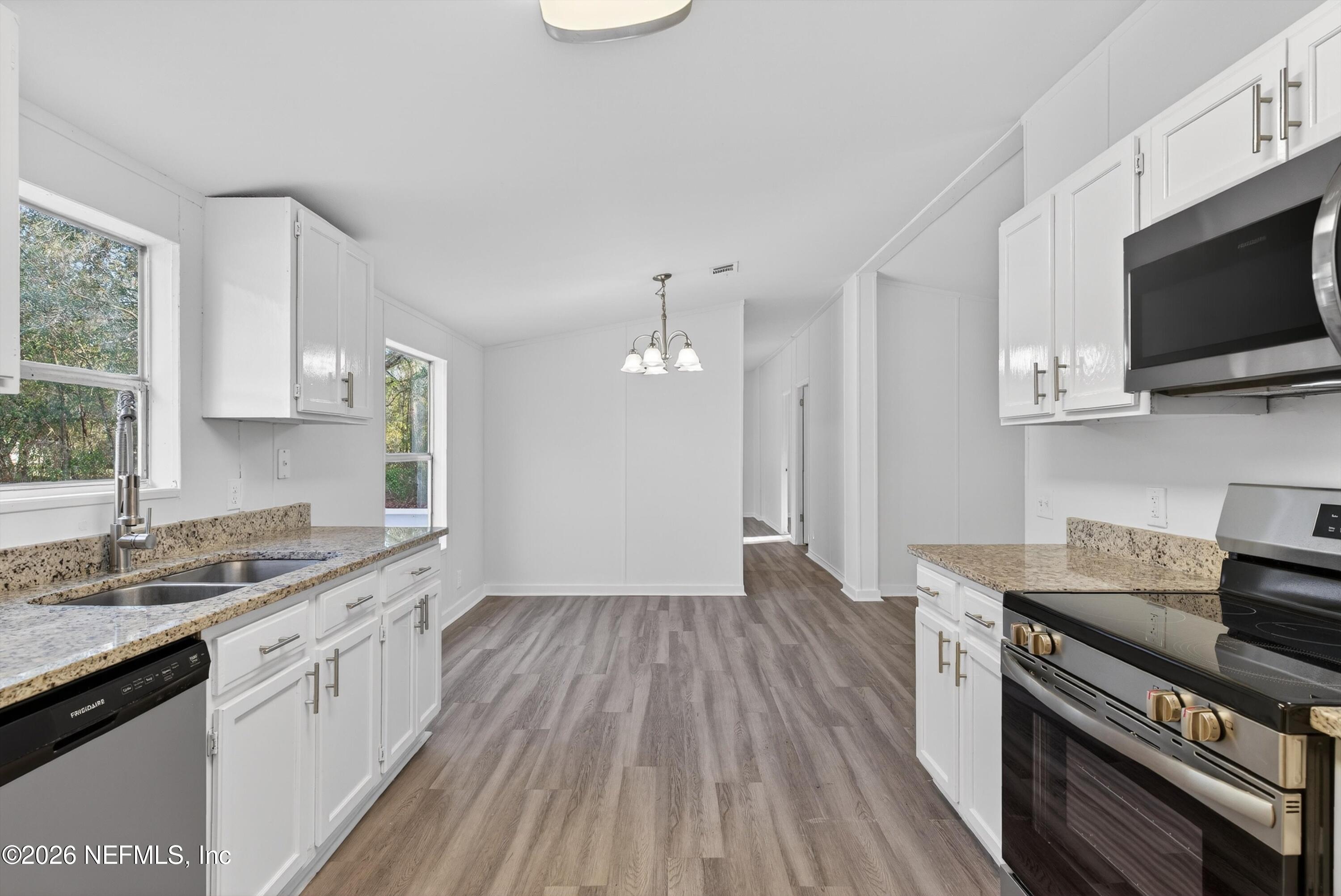 7595 Oak Forest Road Keystone Heights, FL 32656 - Photo 19 of 49 a kitchen with a sink stove and microwave