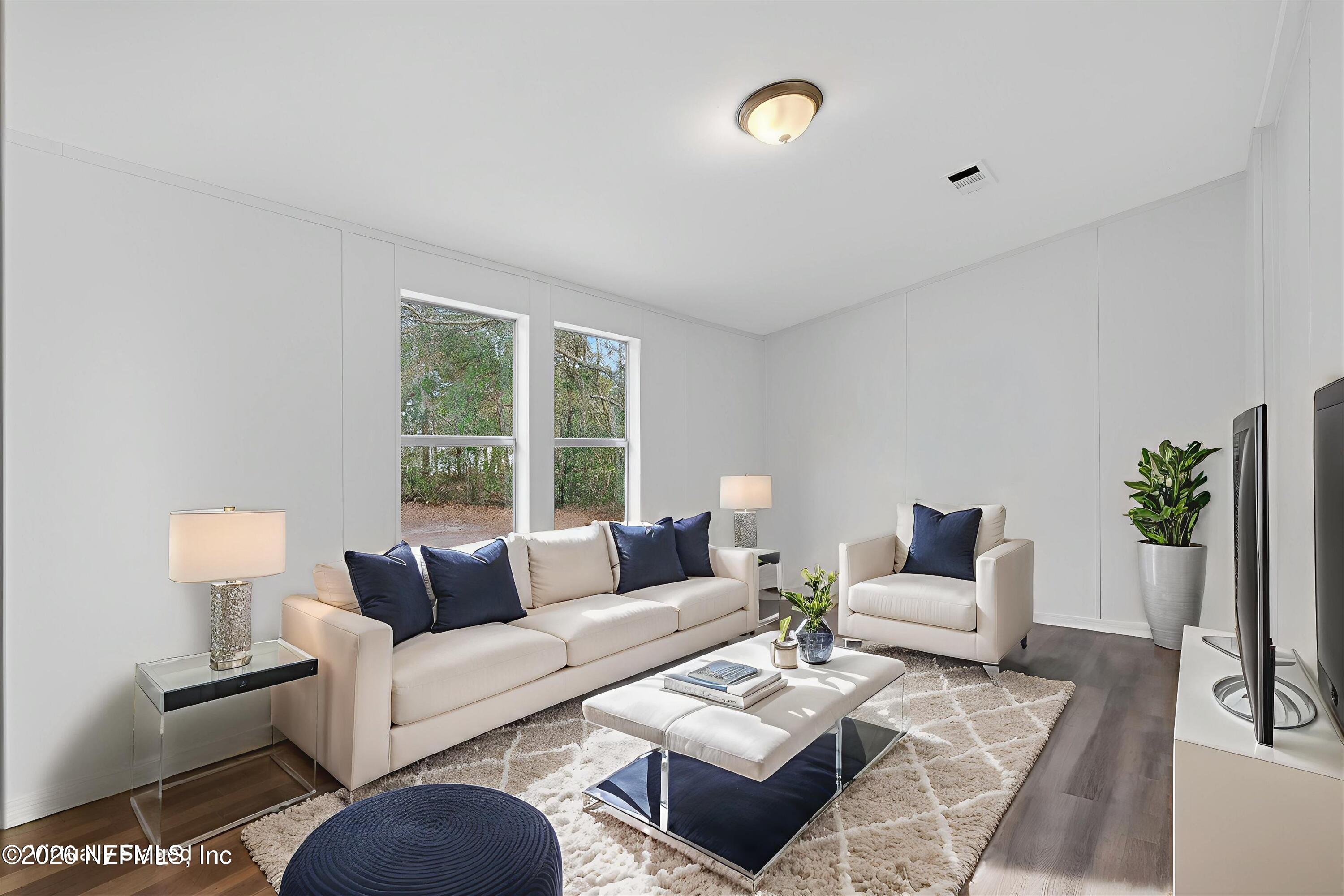 7595 Oak Forest Road Keystone Heights, FL 32656 - Photo 20 of 49 a living room with furniture potted plant and a window