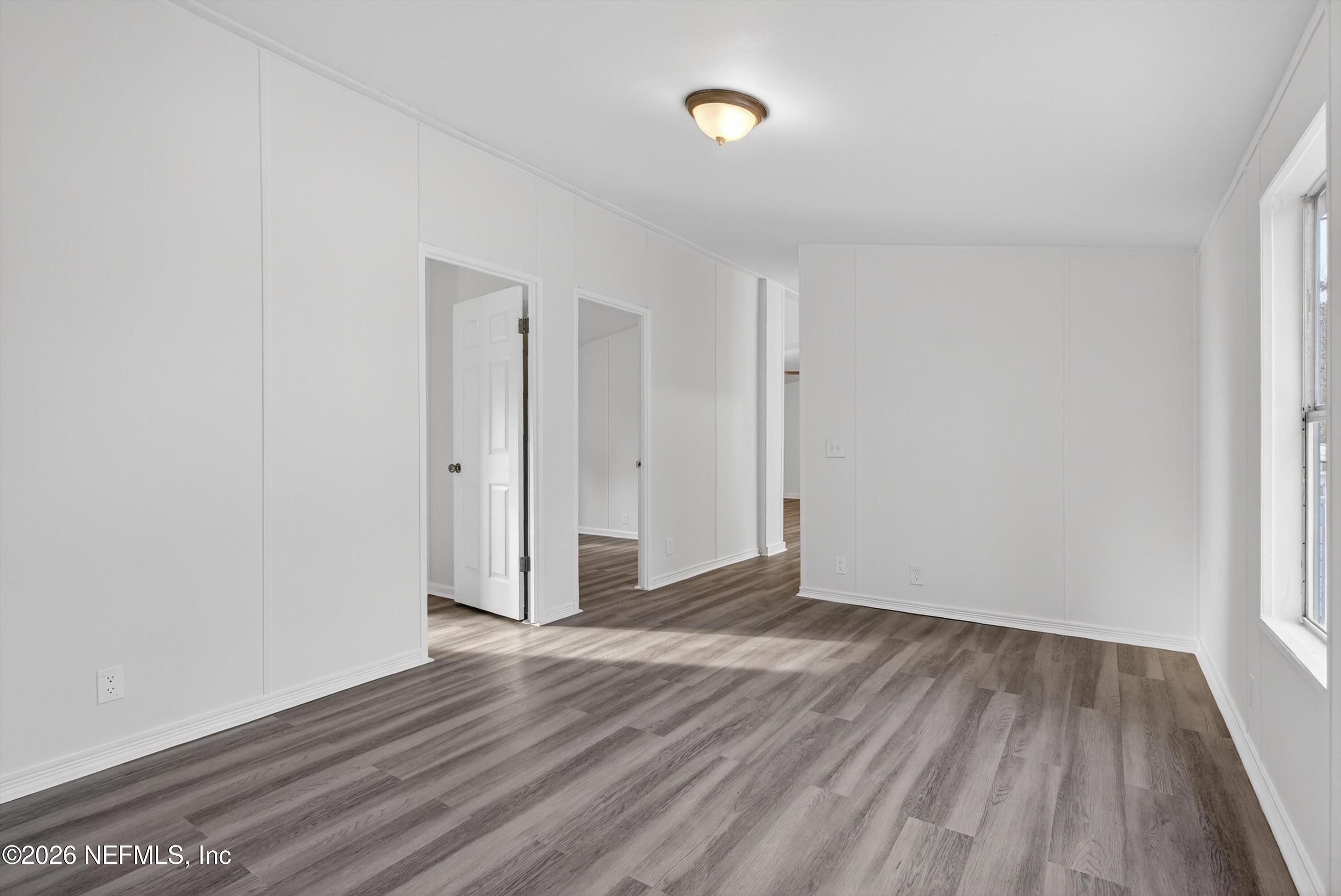 7595 Oak Forest Road Keystone Heights, FL 32656 - Photo 22 of 49 a view of an empty room with wooden floor