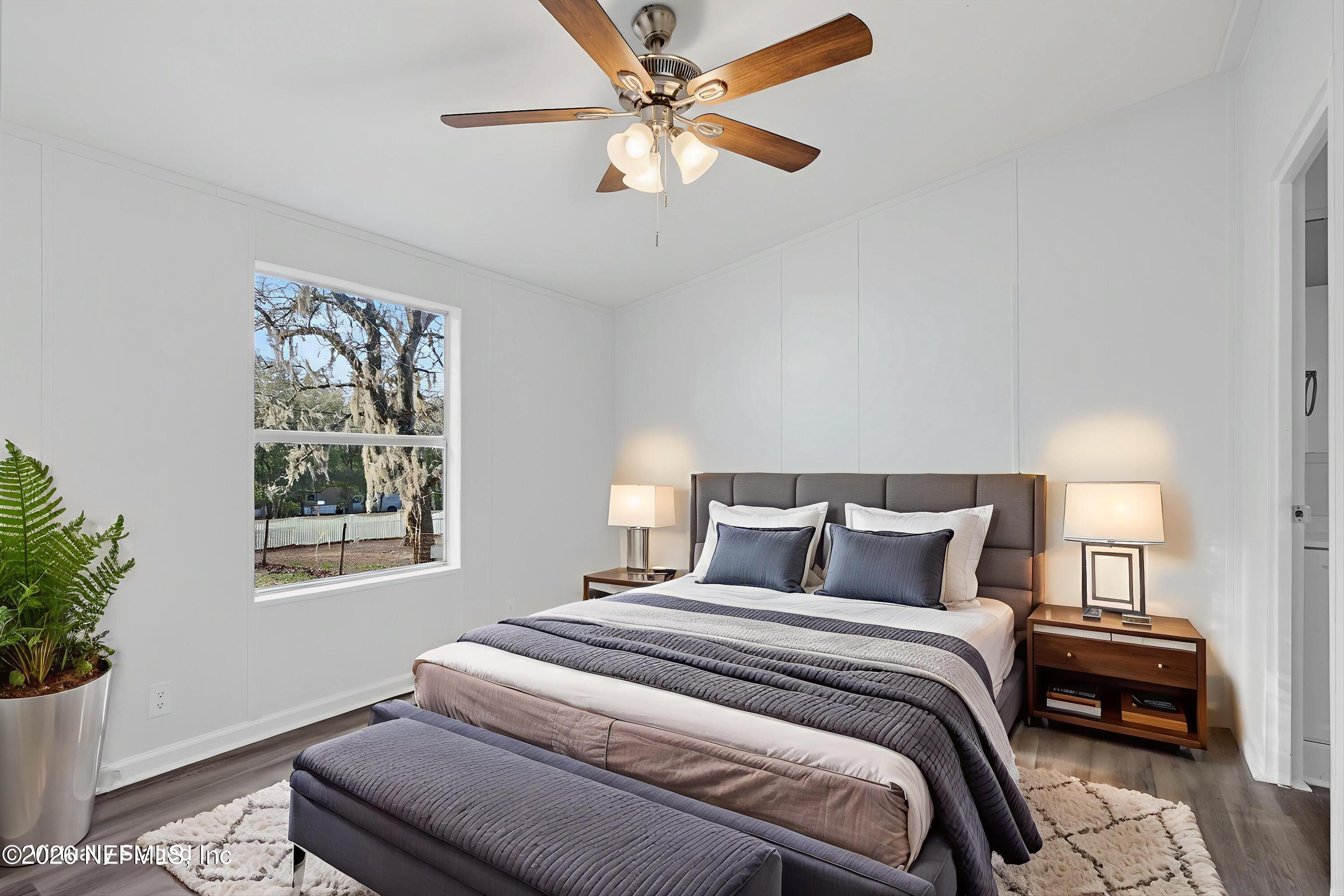 7595 Oak Forest Road Keystone Heights, FL 32656 - Photo 23 of 49 a bedroom with a bed and a potted plant