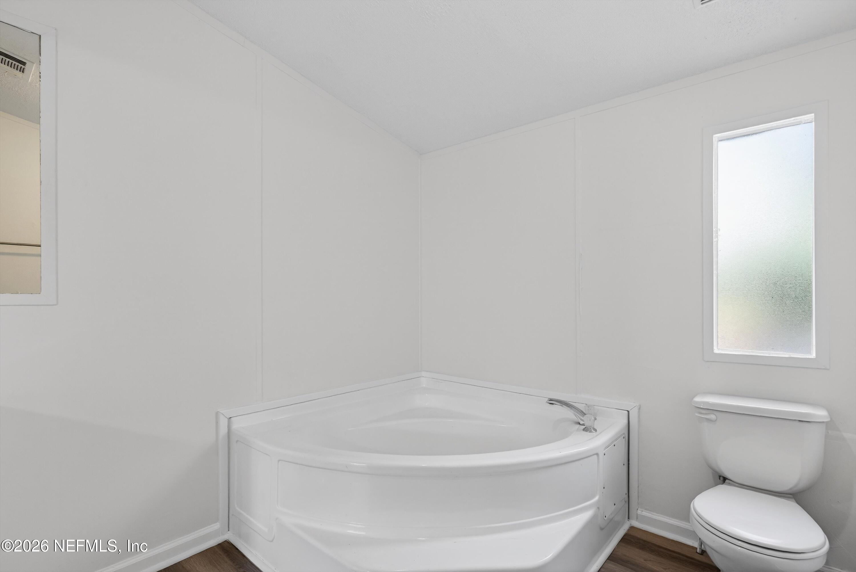 7595 Oak Forest Road Keystone Heights, FL 32656 - Photo 26 of 49 a white bath tub sitting next to a white toilet