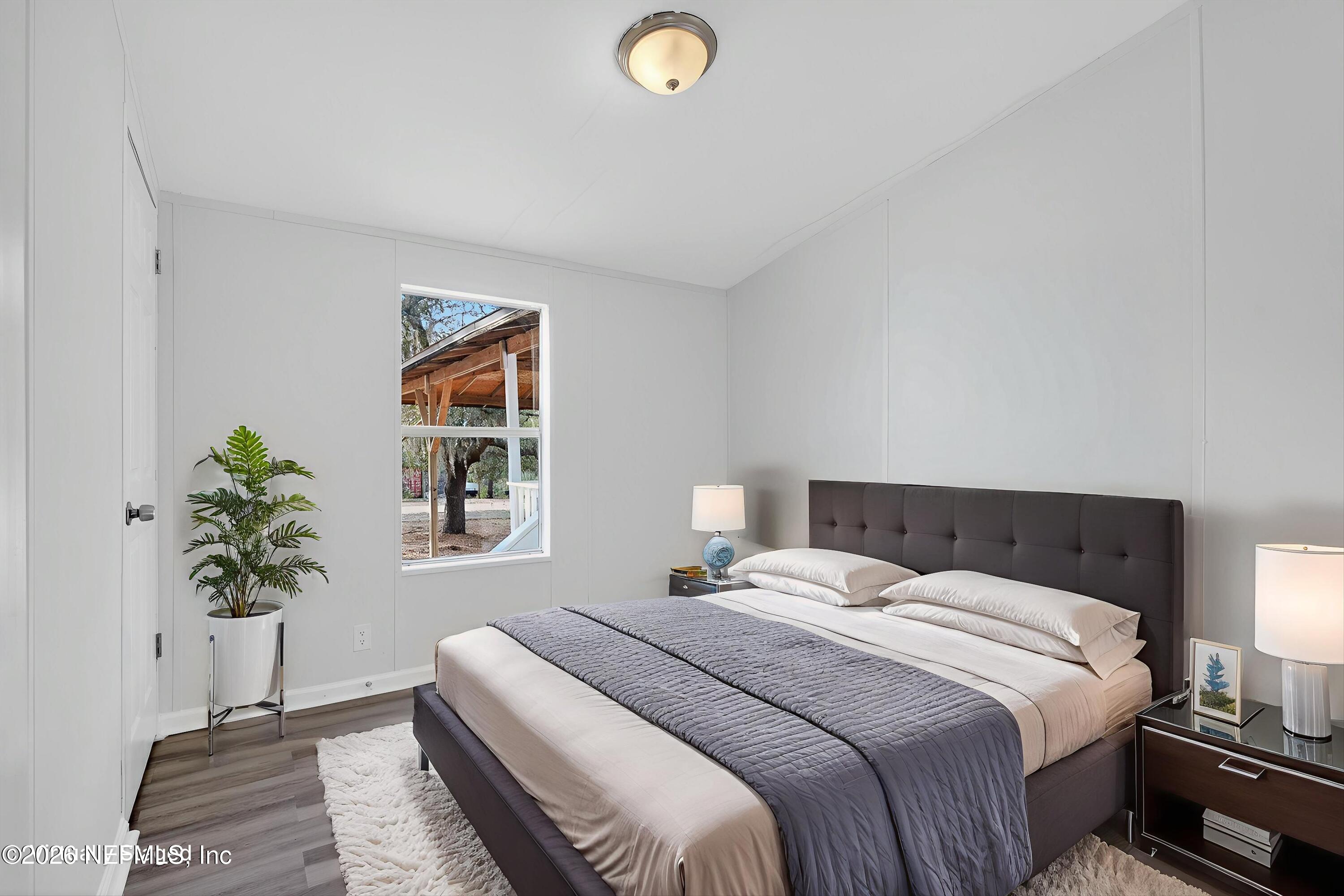 7595 Oak Forest Road Keystone Heights, FL 32656 - Photo 28 of 49 a bedroom with a bed and a potted plant