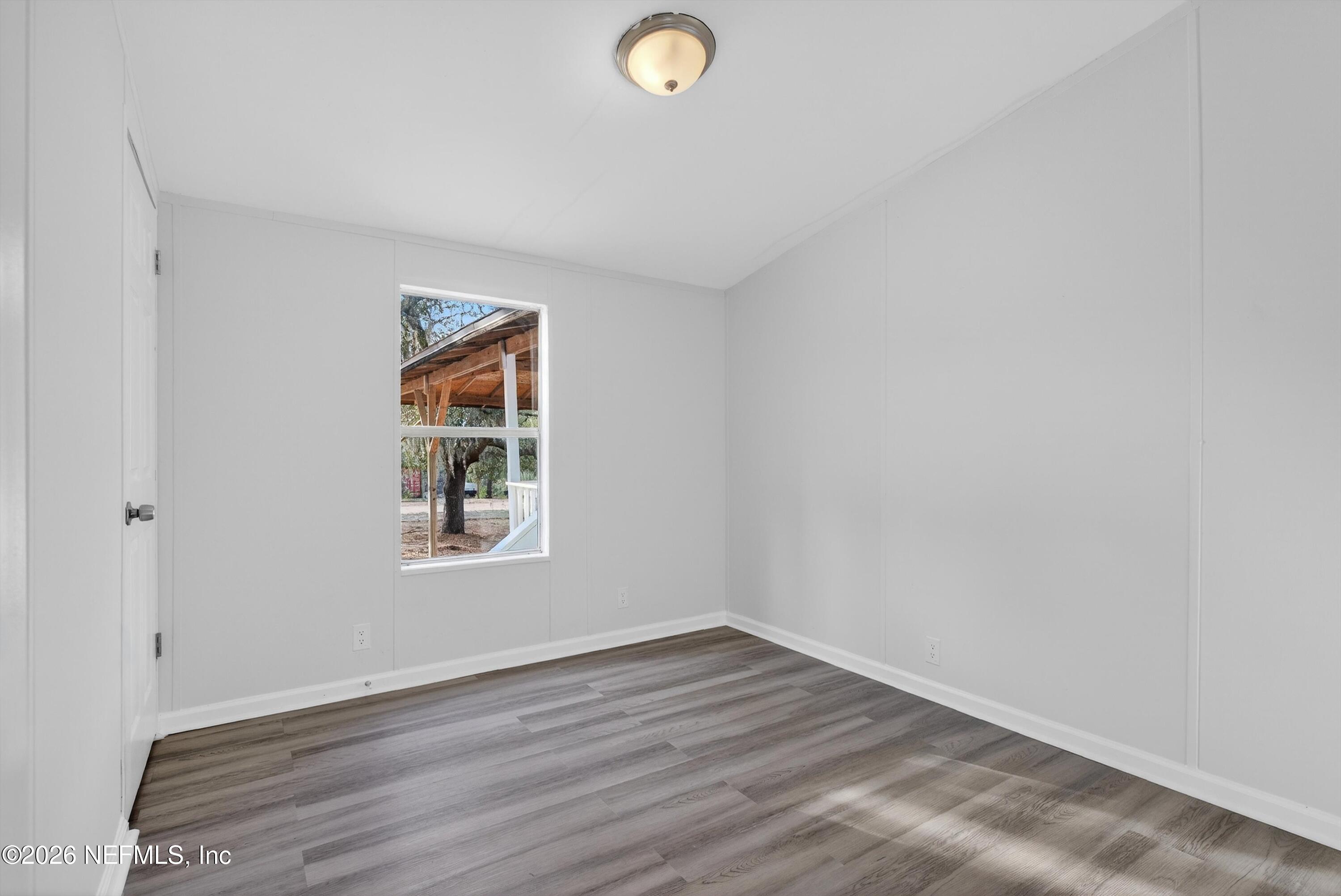 7595 Oak Forest Road Keystone Heights, FL 32656 - Photo 29 of 49 a view of empty room with wooden floor and fan