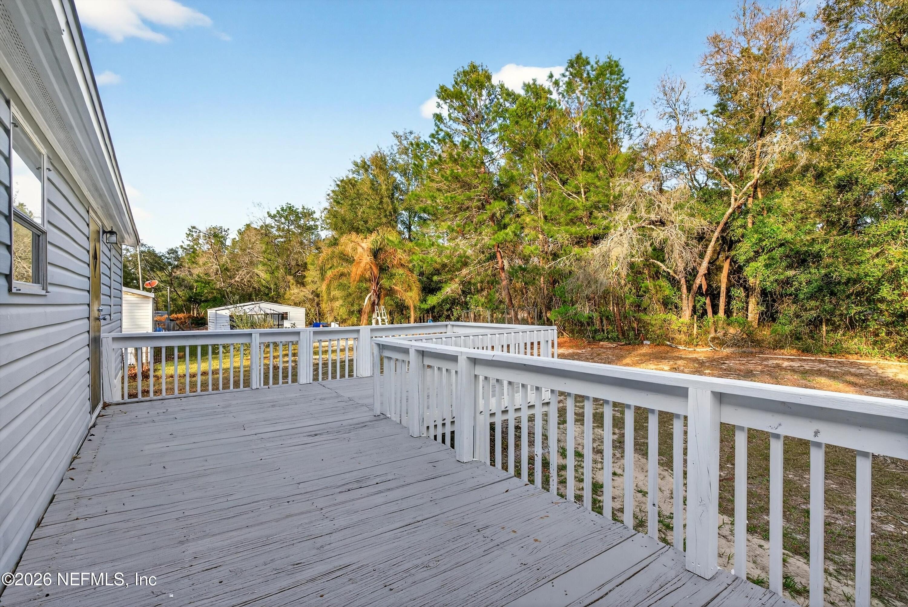 7595 Oak Forest Road Keystone Heights, FL 32656 - Photo 39 of 49 a balcony with wooden floor and fence