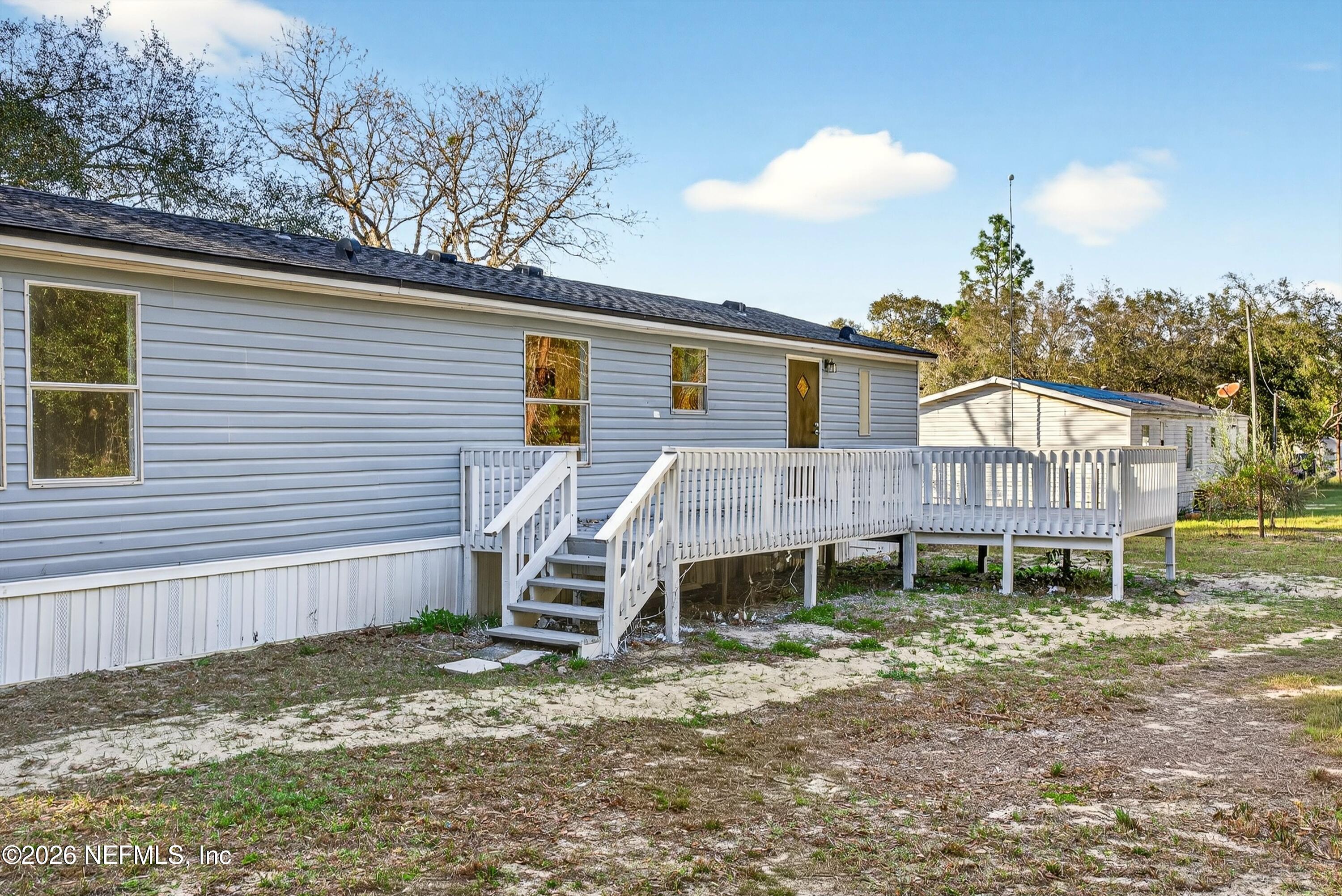7595 Oak Forest Road Keystone Heights, FL 32656 - Photo 42 of 49 a backyard of a house with table and chairs