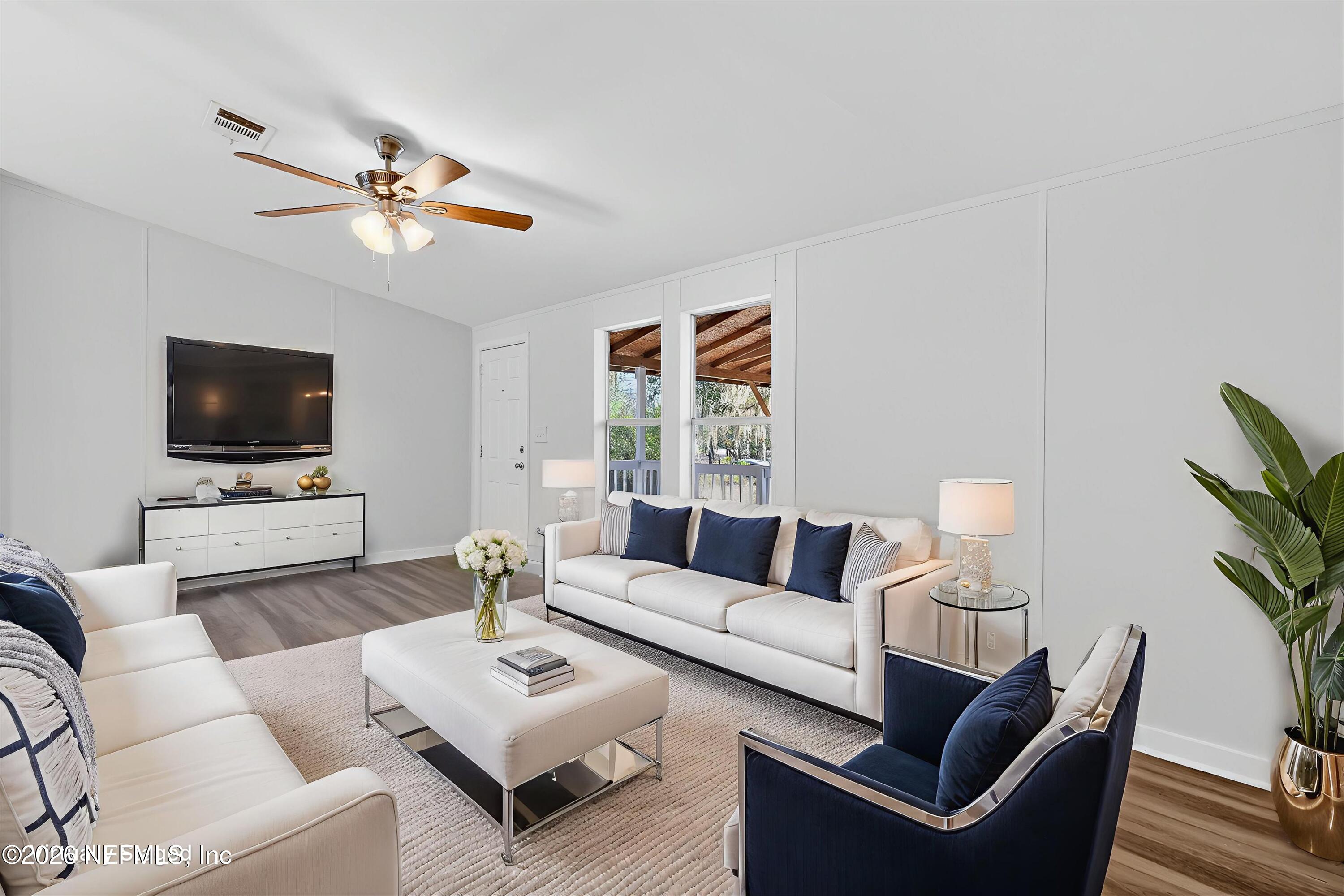7595 Oak Forest Road Keystone Heights, FL 32656 - Photo 7 of 49 a living room with furniture a flat screen tv and a window