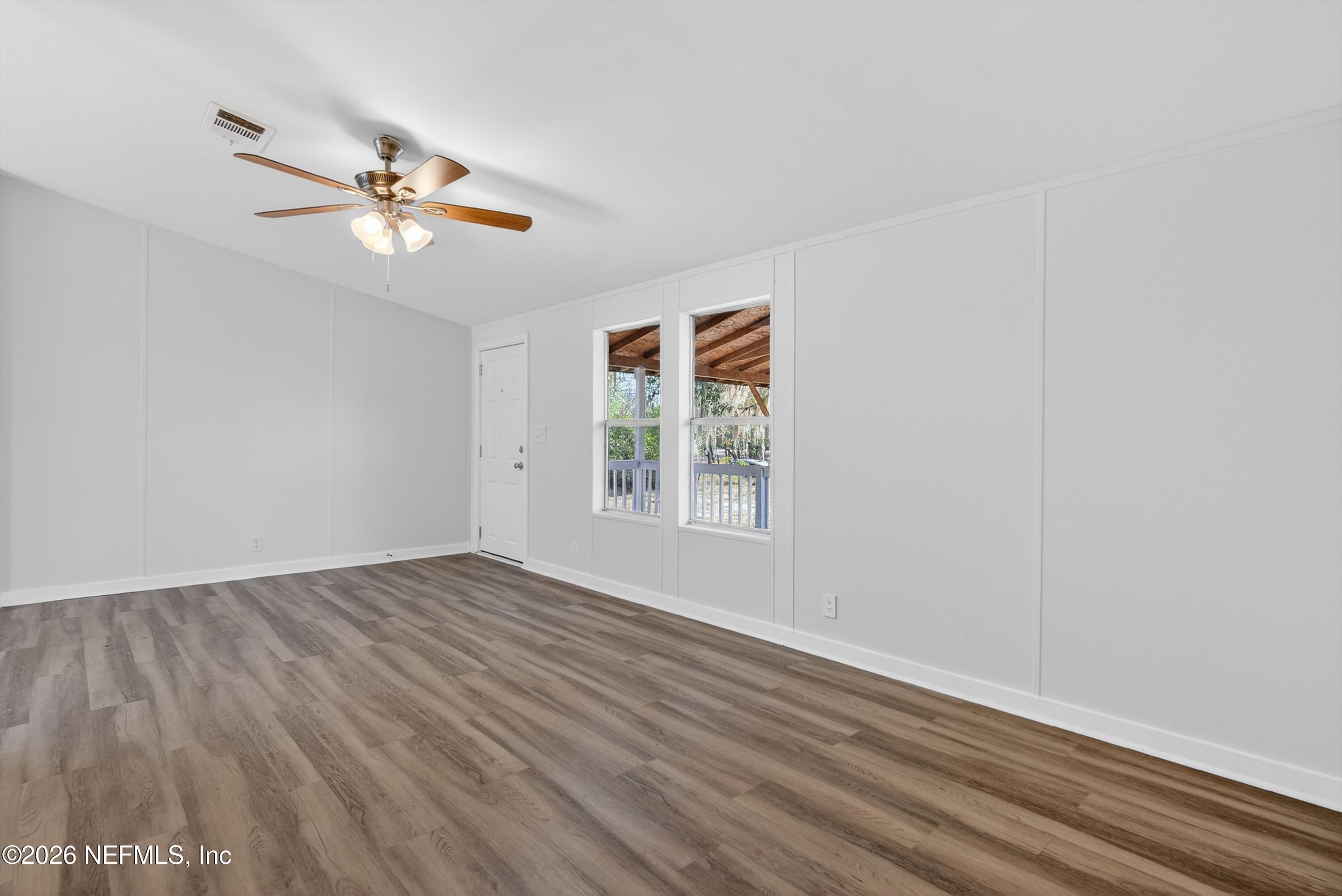 7595 Oak Forest Road Keystone Heights, FL 32656 - Photo 8 of 49 wooden floor in an empty room with a window