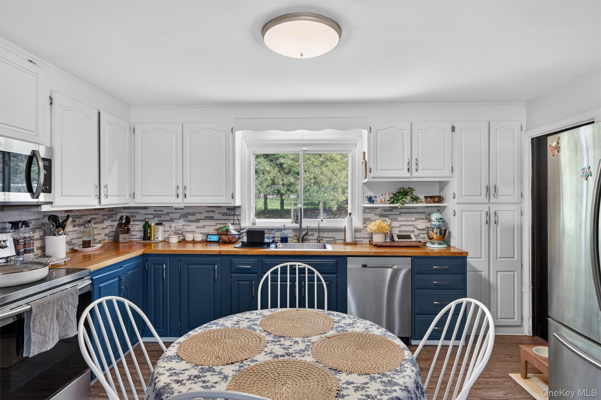 151 Laroe Road Chester, NY 10918 - Photo 18 of 43 a kitchen with stainless steel appliances granite countertop a sink a stove a dining table and chairs