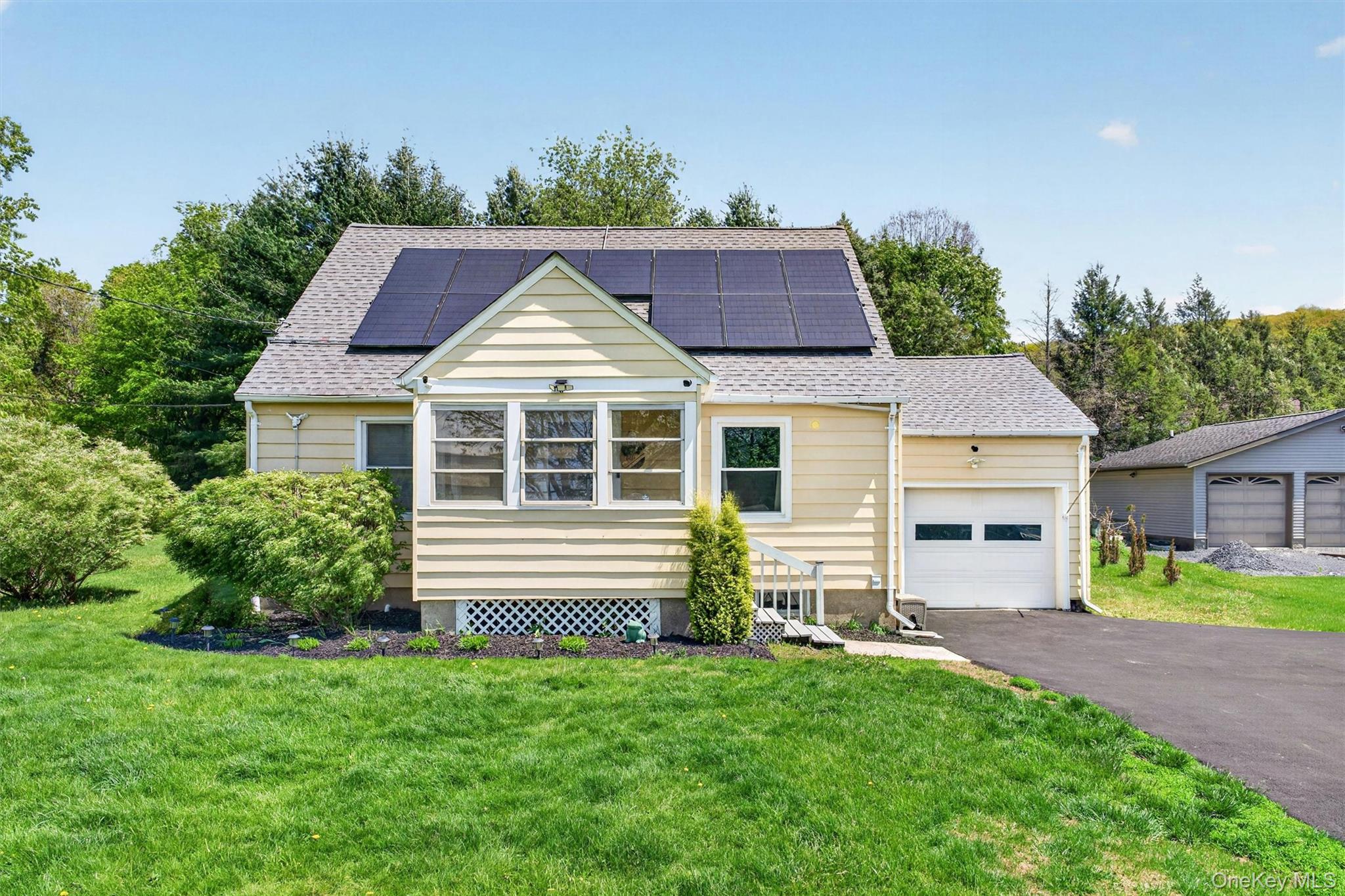 151 Laroe Road Chester, NY 10918 - Photo 2 of 43 a front view of a house with a yard and garage
