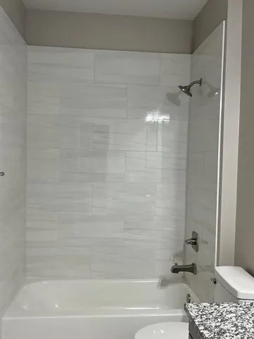 a bathroom with a shower and a tub