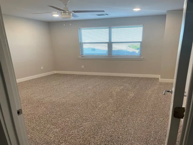 an empty room with a empty space and windows