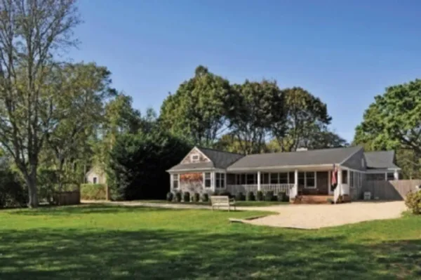 a front view of a house with a garden
