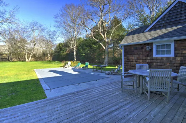a view of a backyard with sitting area furniture and garden