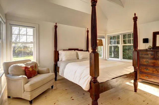 a bedroom with a bed and glass window