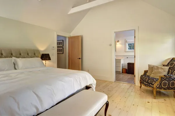 a bedroom with a bed and a chair