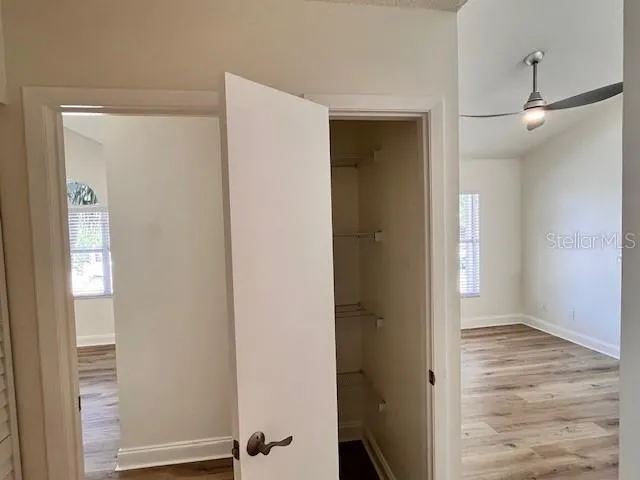 a view of a hallway view with wooden floor and staircase