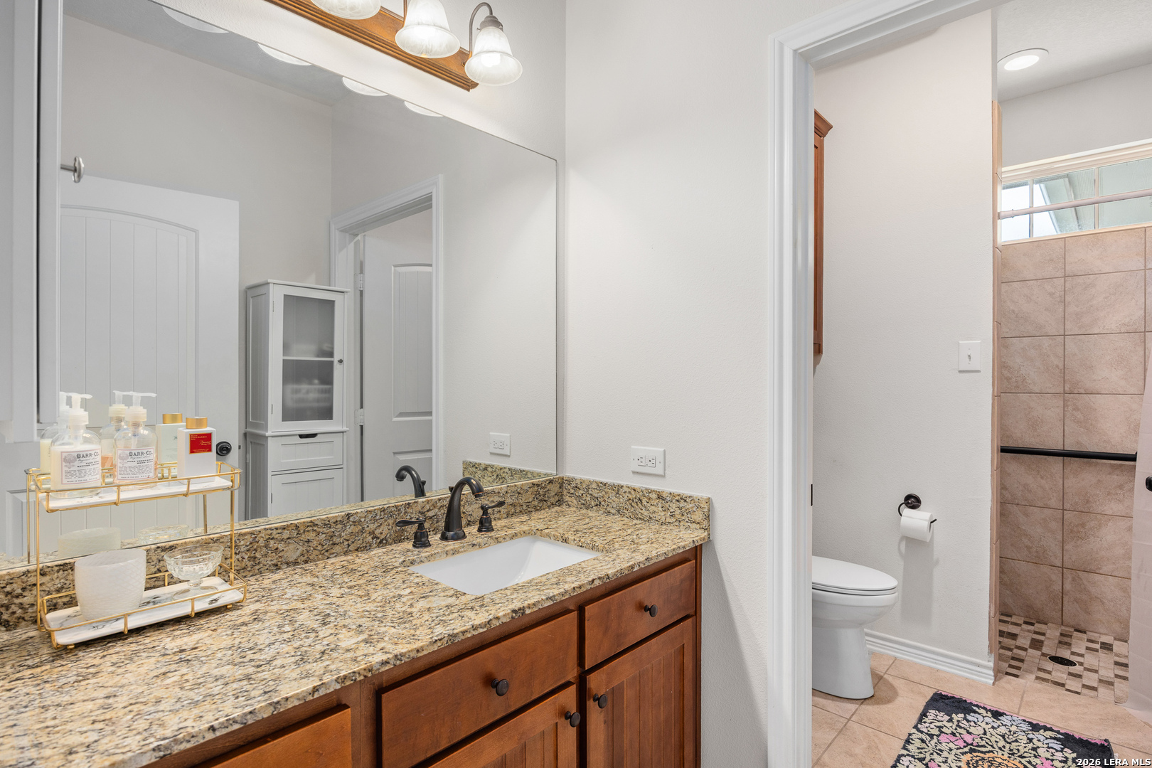 201 Cedar Cliff Loop West Hunt, TX 78024 - Photo 14 of 33 a bathroom with a granite countertop sink and a mirror