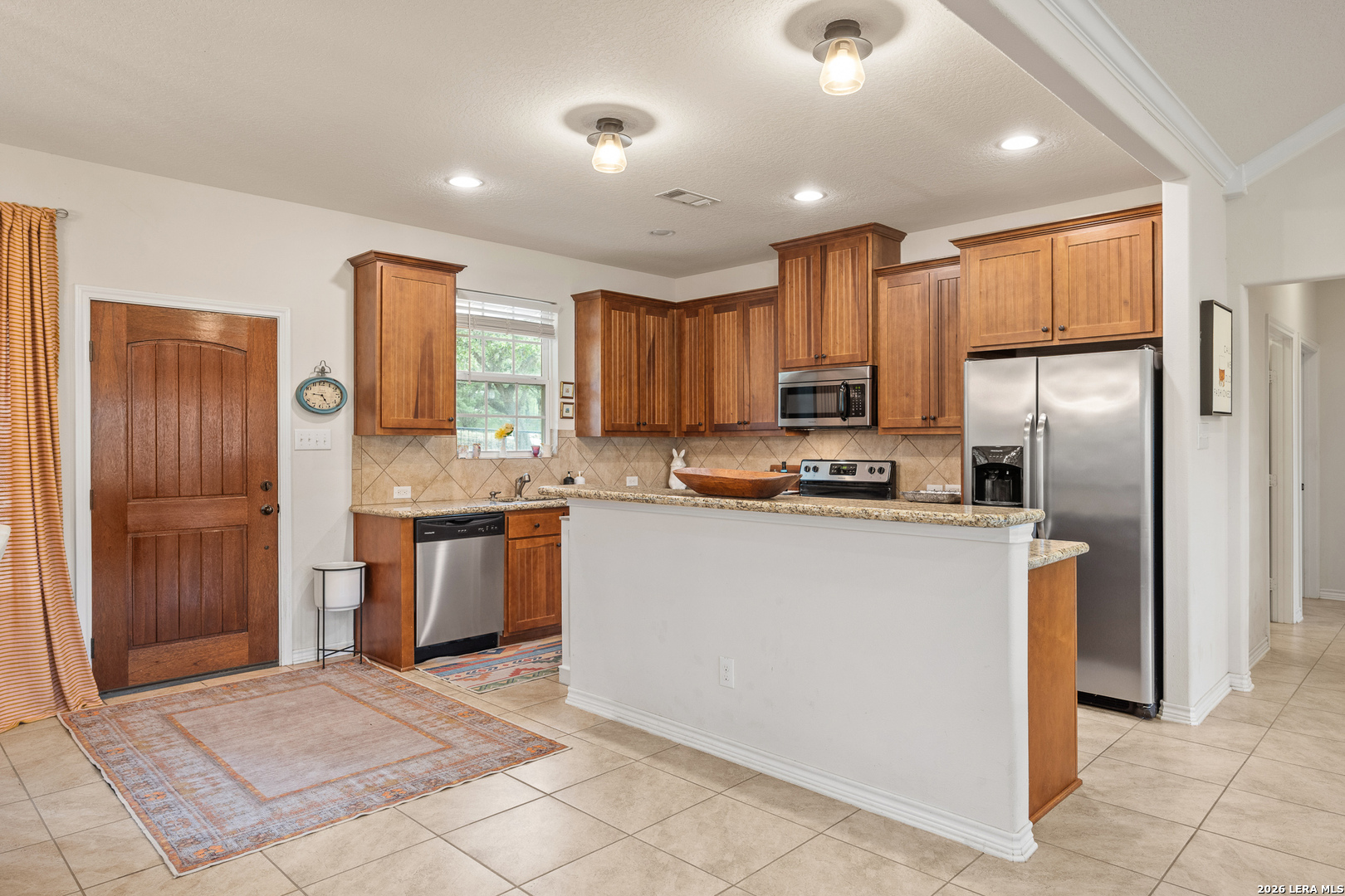 201 Cedar Cliff Loop West Hunt, TX 78024 - Photo 5 of 33 a kitchen with stainless steel appliances granite countertop a refrigerator stove top oven and sink