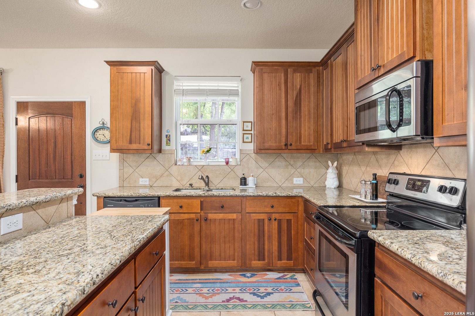201 Cedar Cliff Loop West Hunt, TX 78024 - Photo 6 of 33 a kitchen with stainless steel appliances granite countertop a sink stove and microwave