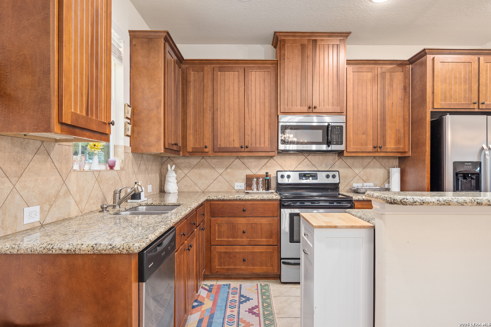 201 Cedar Cliff Loop West Hunt, TX 78024 - Photo 7 of 33 a kitchen with granite countertop a sink a stove and cabinets