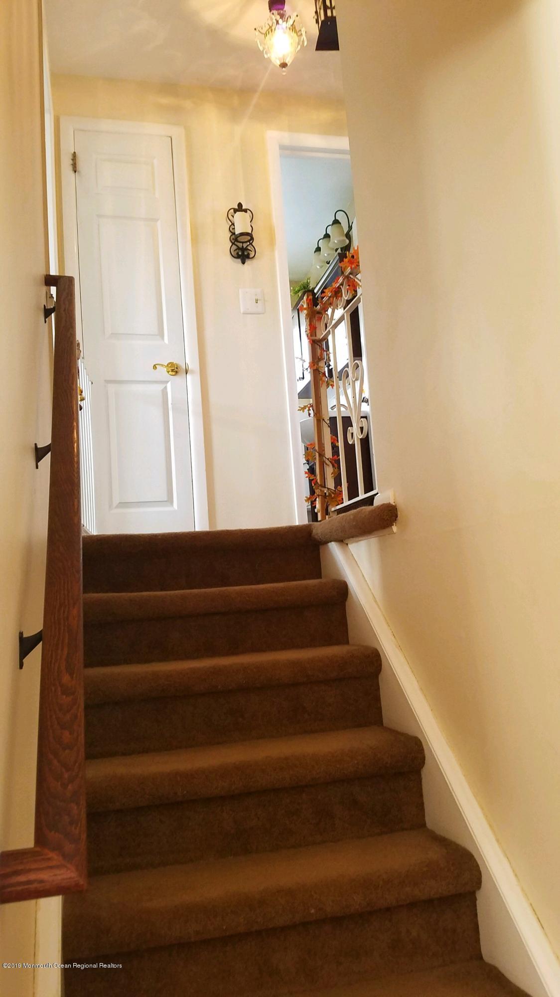 42 Bolton Road Hamilton, NJ 08610 - Photo 11 of 22 a view of staircase with white walls and a window