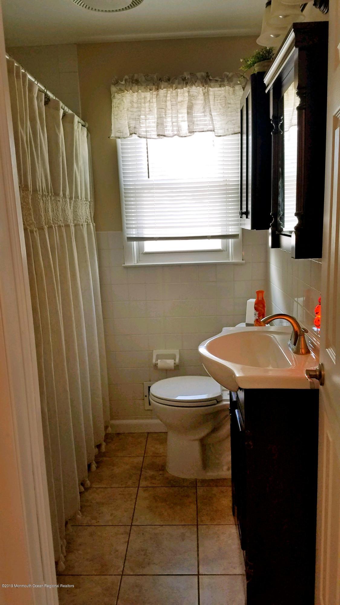 42 Bolton Road Hamilton, NJ 08610 - Photo 12 of 22 a bathroom with a sink a toilet and a mirror