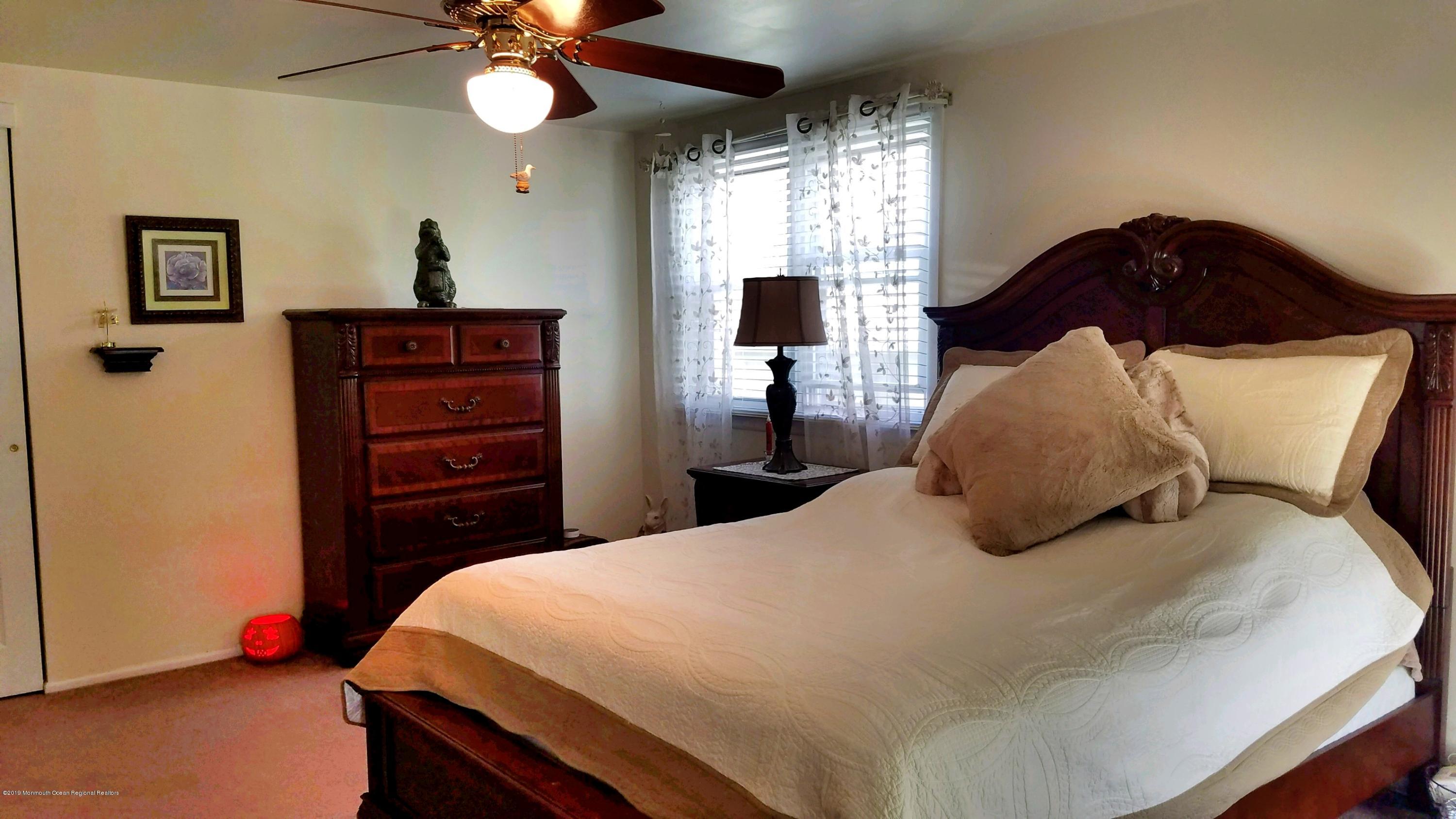 42 Bolton Road Hamilton, NJ 08610 - Photo 19 of 22 a bedroom with a bed and a chandelier