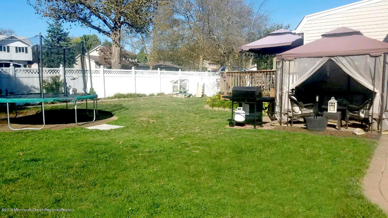 42 Bolton Road Hamilton, NJ 08610 - Photo 22 of 22 a view of backyard with a table and chairs under an umbrella