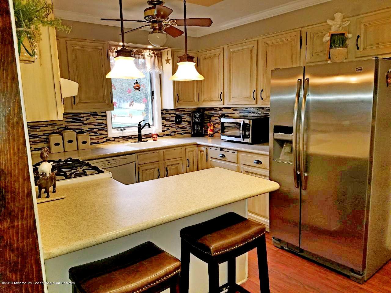 42 Bolton Road Hamilton, NJ 08610 - Photo 7 of 22 a kitchen with stainless steel appliances a refrigerator a sink and white cabinets