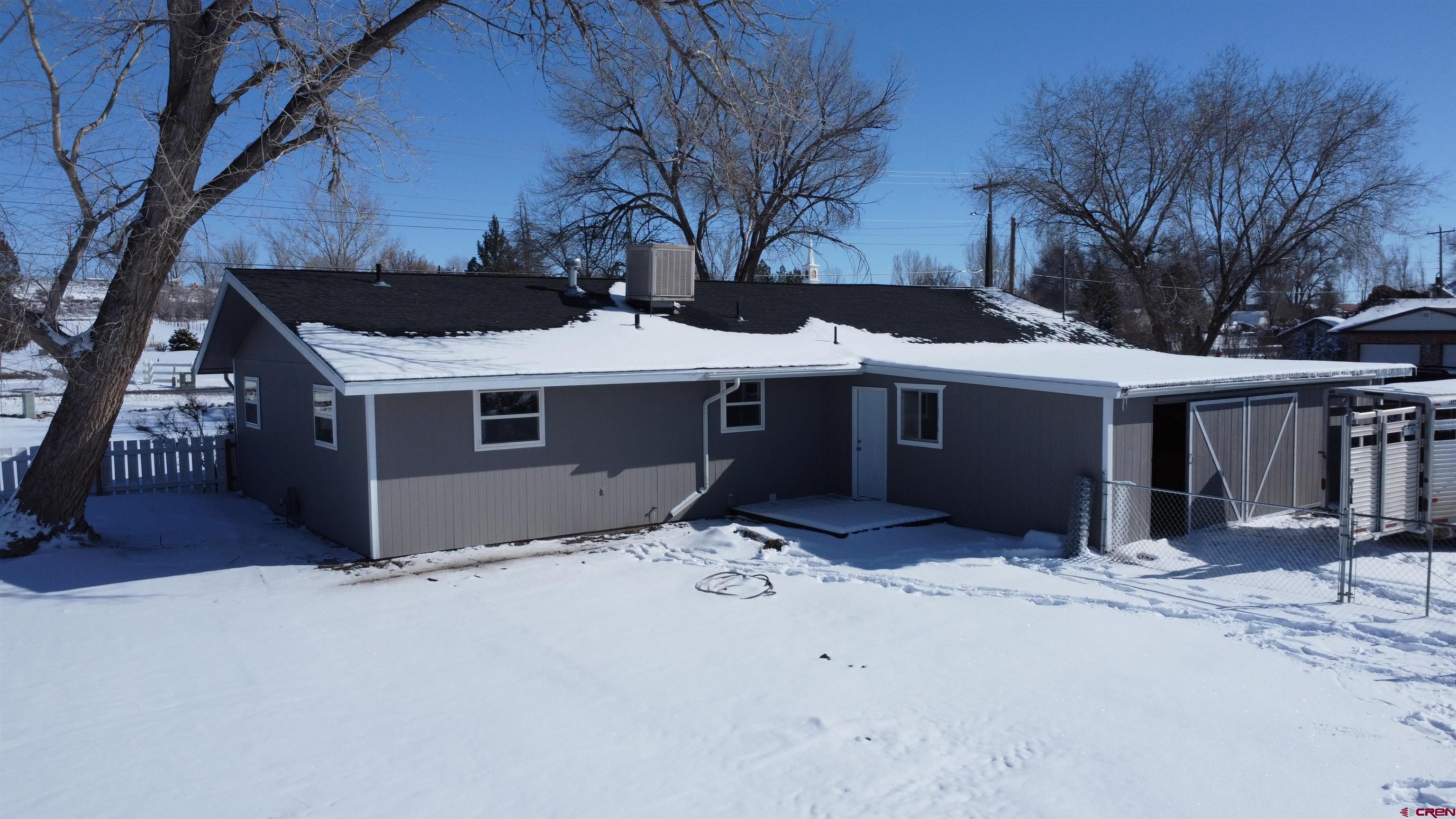 1191 Pioneer Road Delta, CO 81416 - Photo 19 of 22 a front view of house with yard covered in snow