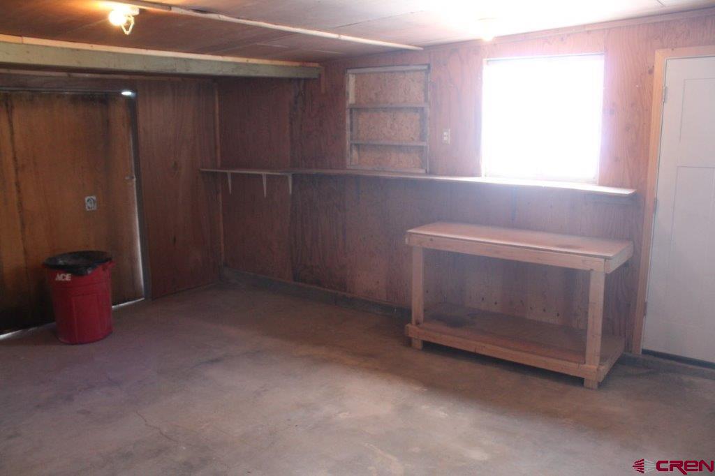 1191 Pioneer Road Delta, CO 81416 - Photo 20 of 22 a room with a fireplace and window