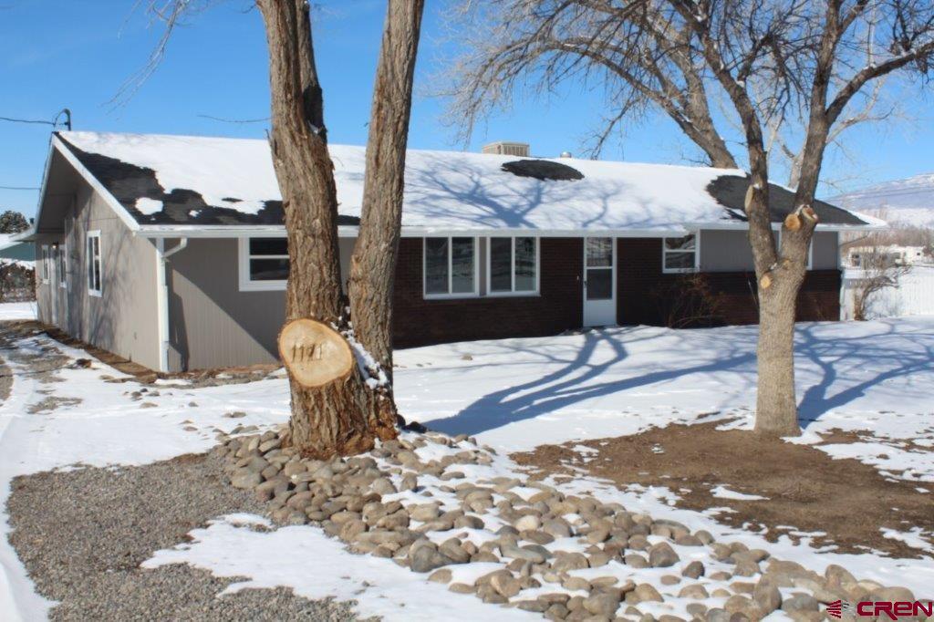 1191 Pioneer Road Delta, CO 81416 - Photo 2 of 22 a front view of house with yard covered in snow