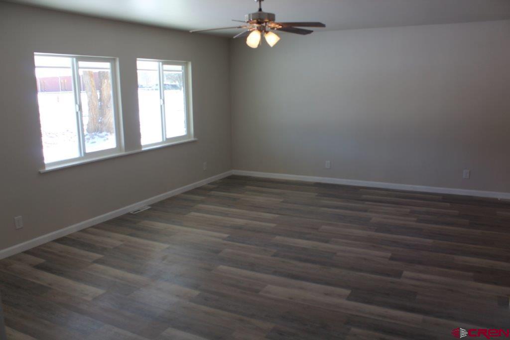 1191 Pioneer Road Delta, CO 81416 - Photo 5 of 22 wooden floor in an empty room with a window