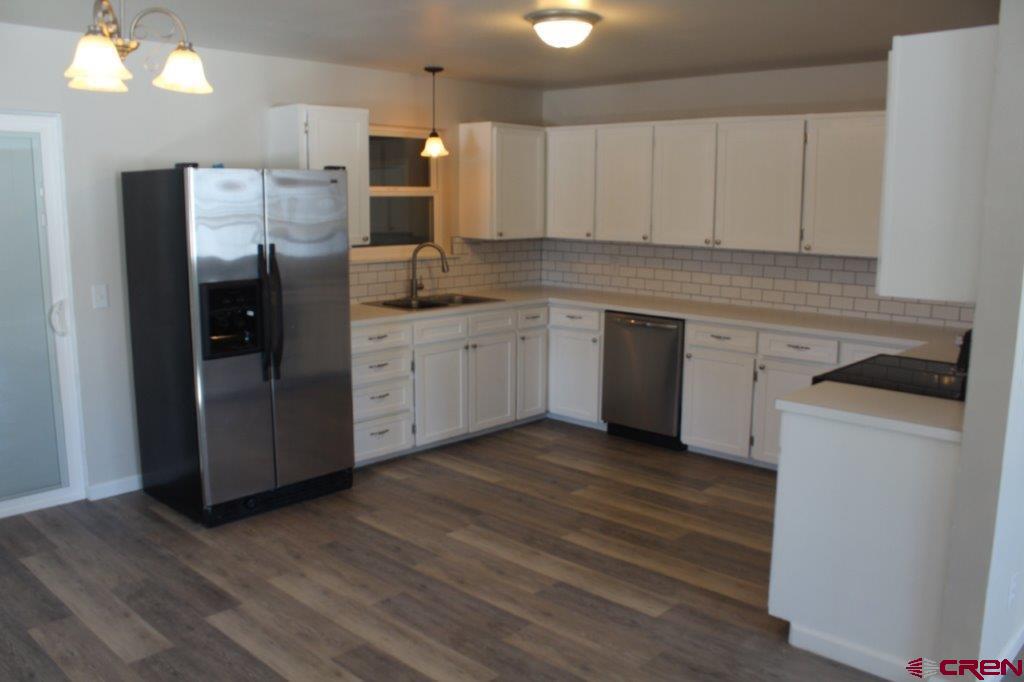 1191 Pioneer Road Delta, CO 81416 - Photo 7 of 22 a kitchen with stainless steel appliances granite countertop a refrigerator and a stove top oven