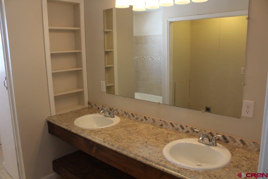 1191 Pioneer Road Delta, CO 81416 - Photo 10 of 22 a bathroom with a sink and a mirror