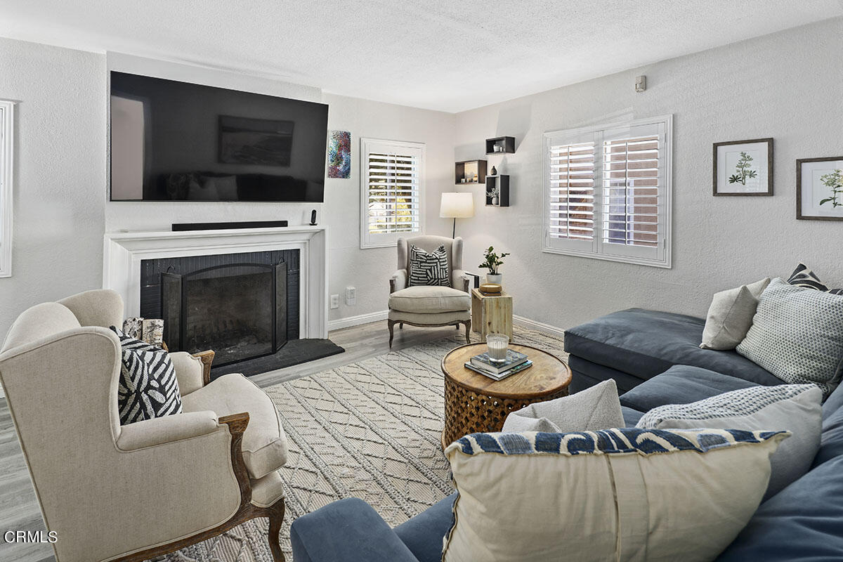 223 Marathon Road Altadena, CA 91001 - Photo 4 of 31 a living room with furniture a fireplace and a flat screen tv