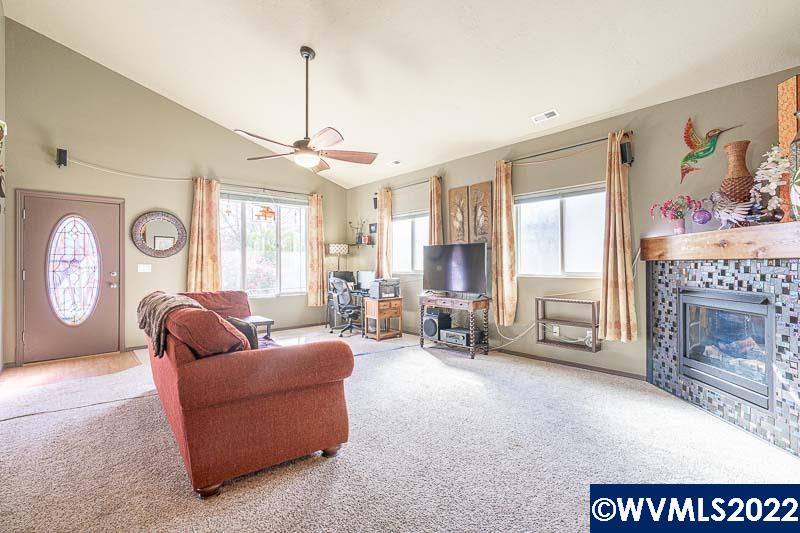 1569 Briar Road Independence, OR 97351 - Photo 4 of 24 a living room with furniture a fireplace and a large window