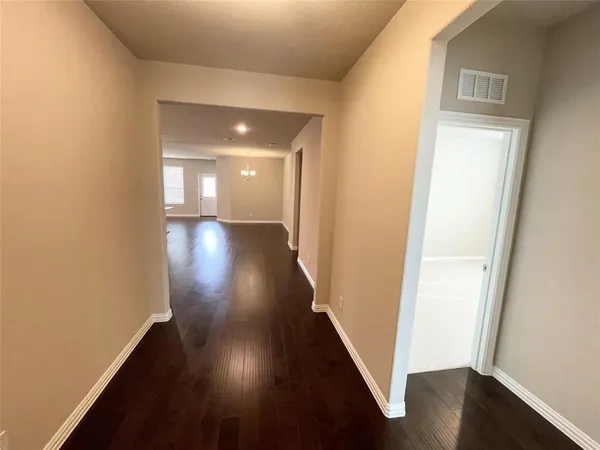 a view of gallery with wooden floor