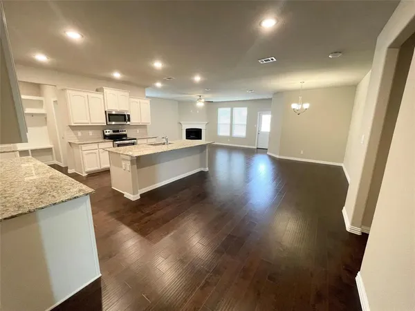 a view of kitchen with sink microwave and stove