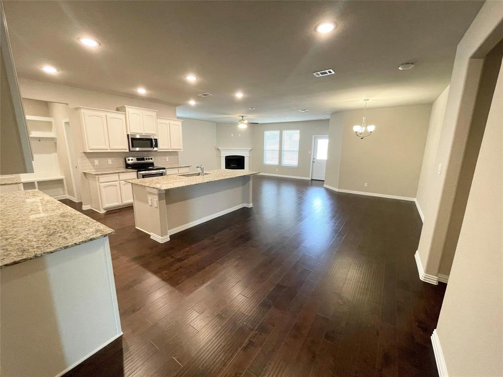 832 Porcupine Drive Springtown, TX 76082 - Photo 5 of 16 a view of kitchen with sink microwave and stove