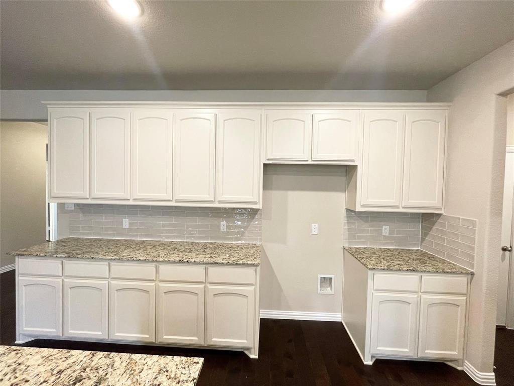 832 Porcupine Drive Springtown, TX 76082 - Photo 8 of 16 a kitchen with granite countertop white cabinets and white appliances