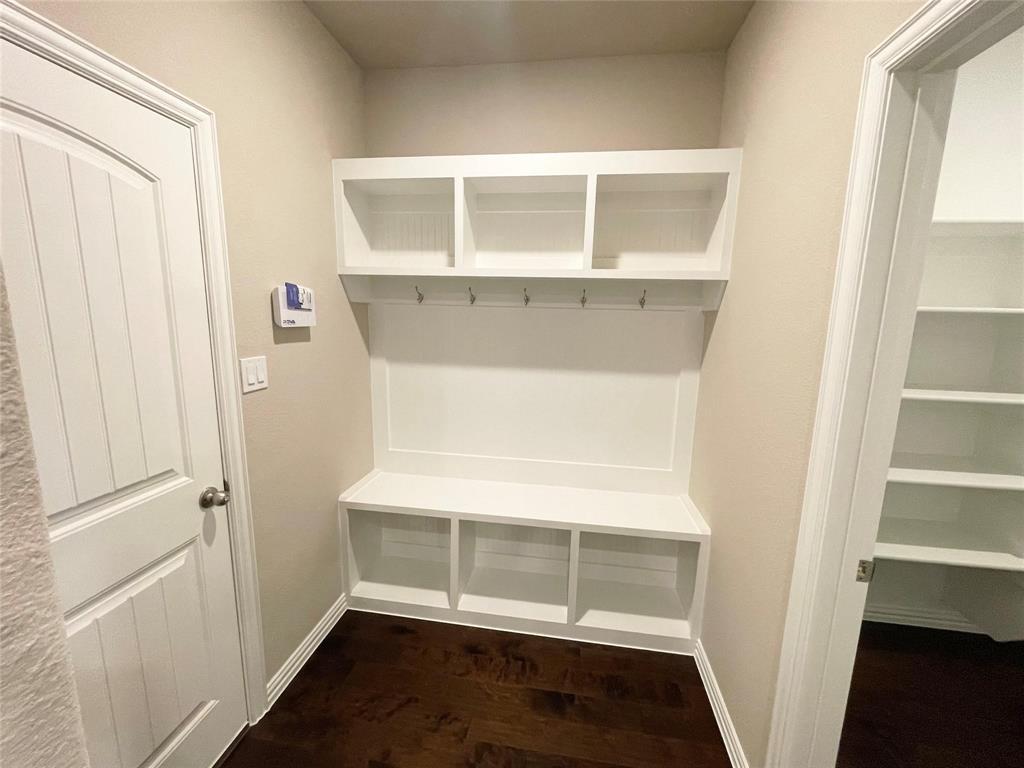 832 Porcupine Drive Springtown, TX 76082 - Photo 9 of 16 a view of an empty room with wooden floor and cabinet